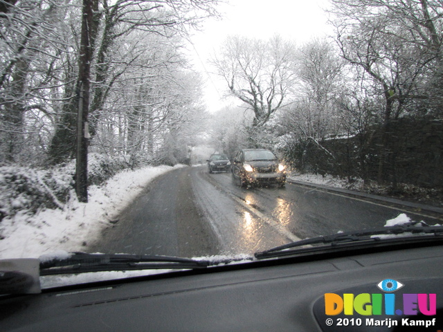 SX17028 Cars driving through snow on country lane